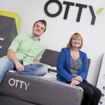 A man and a woman sat on an OTTY mattress