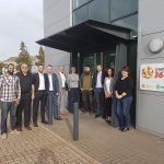 A group of employees stood outside an office building