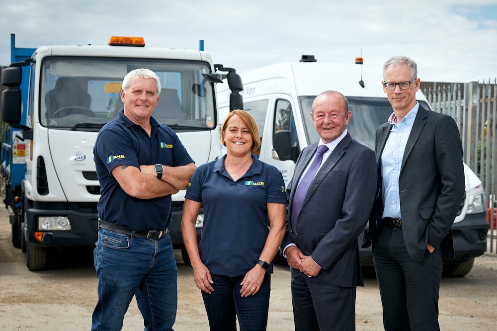 3 men and a woman from GNE Contracting Limited stood outside in front of a lorry and a van