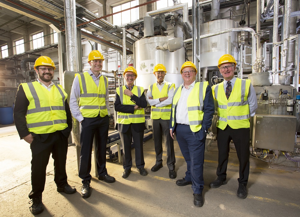 6 men in Hi Vis jackets and hard hats stood in a biomass facility