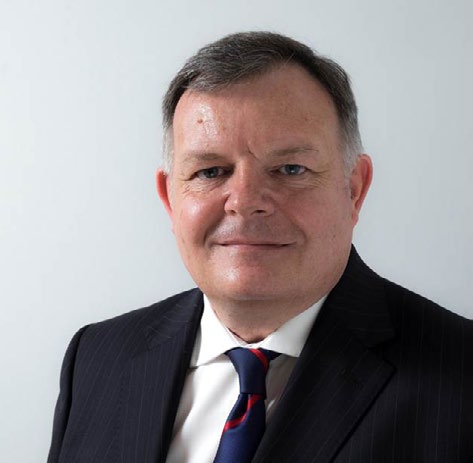 A headshot of Steve Fogg wearing a suit and tie