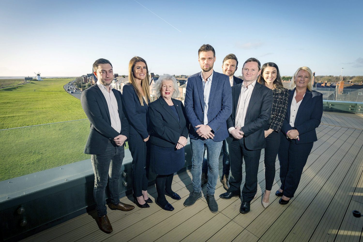 Employees from Get Work standing on a balcony overlooking a town