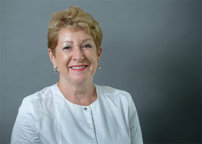 A headshot of a woman smiling