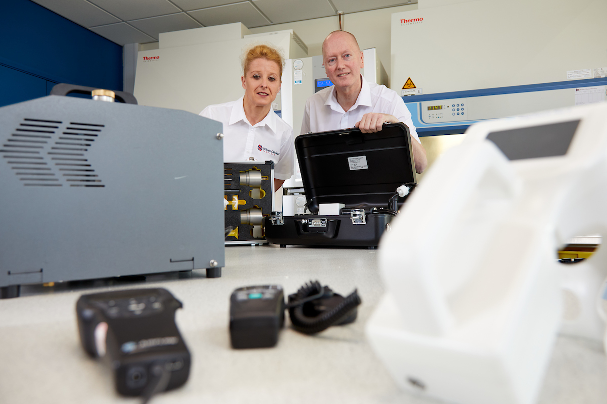 Woman to the left of man working in a laboratory