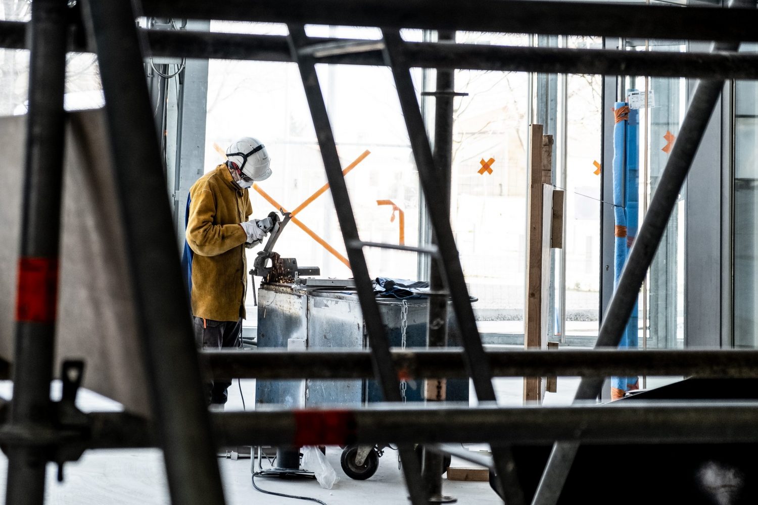 A man dressed in protective clothing working in a racking trolley manufacturer